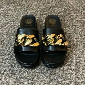 Black and gold flips by Vince Camuto. Brand new and never worn.